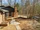 Brick home featuring a wooden deck, chimney, and brick paver patio at 3217 Stoneyford Ct, Raleigh, NC 27603