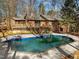 In-ground pool is surrounded by the home, wooden deck and a private wooded backyard at 3217 Stoneyford Ct, Raleigh, NC 27603