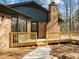 Brick home featuring a wooden deck and chimney at 3217 Stoneyford Ct, Raleigh, NC 27603