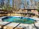In-ground pool is surrounded by the home, wooden deck and a private wooded backyard at 3217 Stoneyford Ct, Raleigh, NC 27603