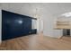 Finished basement featuring hardwood floors, blue accent wall, kitchenette and large window at 3217 Stoneyford Ct, Raleigh, NC 27603