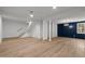 Finished basement with hardwood floors, recessed lighting, and a decorative blue accent wall at 3217 Stoneyford Ct, Raleigh, NC 27603