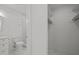 View of toilet and walk-in closet of this all-white modern-style bathroom at 3217 Stoneyford Ct, Raleigh, NC 27603