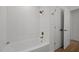 This bathroom features a bathtub and shower with new tile and gold fixtures at 3217 Stoneyford Ct, Raleigh, NC 27603
