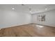 Bright bedroom with hardwood floors, a ceiling fan, and a large window at 3217 Stoneyford Ct, Raleigh, NC 27603