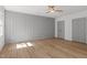 This bedroom has hardwood floors, a ceiling fan, and a paneled accent wall at 3217 Stoneyford Ct, Raleigh, NC 27603