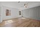 This bedroom has natural light, hardwood flooring, and paneled accent wall at 3217 Stoneyford Ct, Raleigh, NC 27603