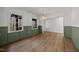 Dining room featuring stylish wainscoting, hardwood floors, and modern lighting at 3217 Stoneyford Ct, Raleigh, NC 27603