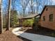Brick home featuring a sidewalk leading to the main house and additional building at 3217 Stoneyford Ct, Raleigh, NC 27603