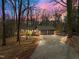 Charming brick home featuring a large driveway, two-car garage, mature trees, and professionally landscaped yard at 3217 Stoneyford Ct, Raleigh, NC 27603