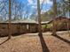 A brick home with mature trees and landscaping, highlighted by a covered entryway at 3217 Stoneyford Ct, Raleigh, NC 27603