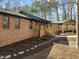 Brick home featuring a covered porch with wood railing and walkway at 3217 Stoneyford Ct, Raleigh, NC 27603