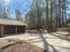 Two car garage with long driveway surrounded by trees and professionally landscaped area at 3217 Stoneyford Ct, Raleigh, NC 27603