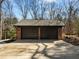 Two car detached garage with black garage doors and ample parking space at 3217 Stoneyford Ct, Raleigh, NC 27603