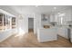 Bright, white kitchen featuring an island, stainless steel appliances, and a bay window with backyard views at 3217 Stoneyford Ct, Raleigh, NC 27603