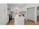 Renovated white kitchen with an island, stainless steel appliances, white subway tile and hardwood floors at 3217 Stoneyford Ct, Raleigh, NC 27603