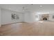Spacious and bright living room with hardwood floors, large windows, and a stone fireplace focal point at 3217 Stoneyford Ct, Raleigh, NC 27603