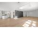 Open-concept living space with skylight and hardwood floors leads to a modern, well-equipped kitchen at 3217 Stoneyford Ct, Raleigh, NC 27603