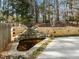 Tranquil backyard pond with stacked stone waterfall feature and mature landscaping at 3217 Stoneyford Ct, Raleigh, NC 27603