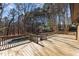 Spacious wooden deck provides an elevated view of the in-ground pool and private wooded backyard at 3217 Stoneyford Ct, Raleigh, NC 27603