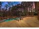 Spacious wooden deck provides an elevated view of the in-ground pool and private wooded backyard at 3217 Stoneyford Ct, Raleigh, NC 27603