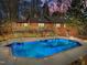 Beautiful in-ground pool with deck, wooden railing, and red brick house in the background at 3217 Stoneyford Ct, Raleigh, NC 27603
