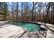 A large in-ground pool surrounded by a concrete patio and a fenced-in yard at 3217 Stoneyford Ct, Raleigh, NC 27603