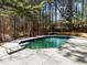An elevated angle of the in-ground pool with the surrounding patio and mature trees at 3217 Stoneyford Ct, Raleigh, NC 27603