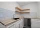 Modern wet bar with butcher block counters, herringbone backsplash, floating shelves, and beverage cooler at 3217 Stoneyford Ct, Raleigh, NC 27603