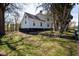 The back of the home featuring a well-maintained yard and traditional architectural details at 347 W Trade St, Burlington, NC 27217