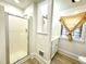 Bathroom with a glass-enclosed shower, and a modern sink with a window above it at 347 W Trade St, Burlington, NC 27217