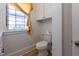 Bathroom featuring a toilet, built in cabinet, and bright natural light at 347 W Trade St, Burlington, NC 27217