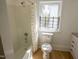 Bathroom featuring a tub shower, toilet, and natural light at 347 W Trade St, Burlington, NC 27217