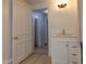 Clean bathroom with a sink and cabinet, and doorways leading to other rooms at 347 W Trade St, Burlington, NC 27217