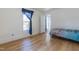 A bright bedroom with wood floors and a blue patterned blanket on the bed at 347 W Trade St, Burlington, NC 27217