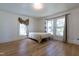 Bedroom featuring a bed, 3 windows, and light hardwood floors at 347 W Trade St, Burlington, NC 27217
