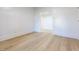 Bright bedroom with light hardwood floors, white walls, and white trim at 347 W Trade St, Burlington, NC 27217