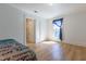 Bright bedroom featuring wood floors, white trim, a cozy blanket, and ample natural light at 347 W Trade St, Burlington, NC 27217