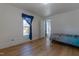 A spacious bedroom with wood floors and bright natural light shining in from the window at 347 W Trade St, Burlington, NC 27217
