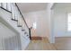 Bright entryway features wood-look floors, stairs, and a white front door with an oval window at 347 W Trade St, Burlington, NC 27217