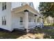 Inviting covered porch with white railings and sturdy columns adds charm to this home's exterior at 347 W Trade St, Burlington, NC 27217