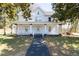 Charming two-story home featuring a covered front porch with white pillars and a well-maintained lawn at 347 W Trade St, Burlington, NC 27217