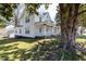 Exterior view of a two-story house with a welcoming front porch and mature trees in a spacious yard at 347 W Trade St, Burlington, NC 27217