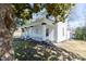 Side view of a charming two-story house with a welcoming front porch and mature trees in a spacious yard at 347 W Trade St, Burlington, NC 27217