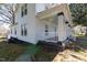 Side view of home with a covered porch, showcasing white railings and classic architectural details at 347 W Trade St, Burlington, NC 27217