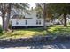 Charming white two-story home featuring a classic design and picturesque surroundings at 347 W Trade St, Burlington, NC 27217