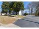 Charming white two-story home with a welcoming front porch and mature shade trees at 347 W Trade St, Burlington, NC 27217