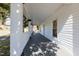 Covered front porch with white columns, offering a glimpse of the surrounding neighborhood and street at 347 W Trade St, Burlington, NC 27217