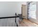 Hallway with white walls, wood floors and a chair, near the stairs at 347 W Trade St, Burlington, NC 27217