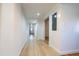 Bright hallway with hardwood floors, neutral walls, and doorways leading to other rooms at 347 W Trade St, Burlington, NC 27217
